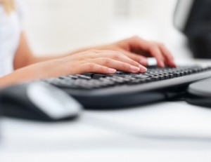 Closeup of a business woman's hand typing on the keyboard